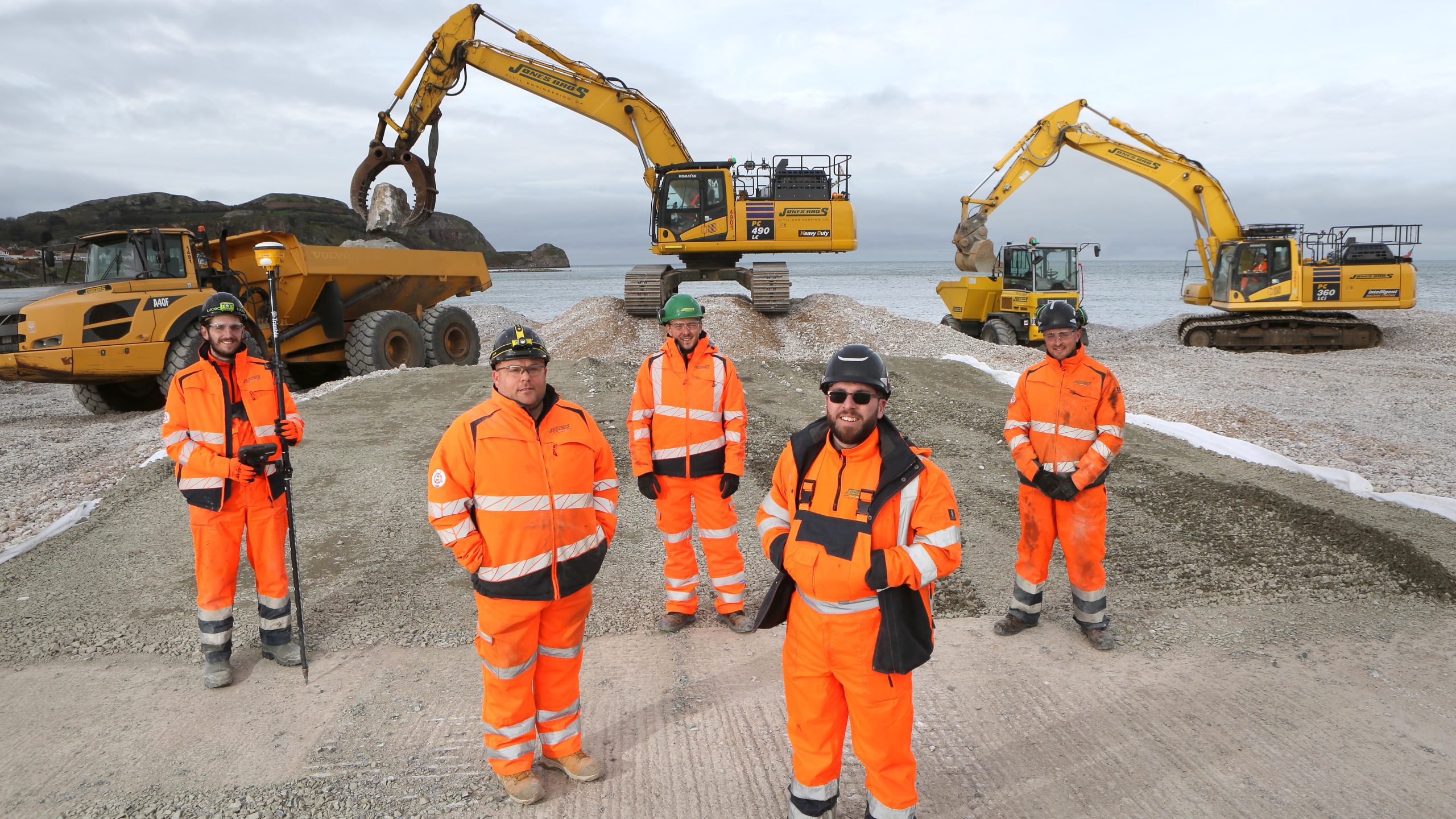 Some of the Jones Bros team working on the multi-million-pound coastal defence scheme at Penrhyn Bay L-R: Jordan Stoneman site engineer; Gareth Jones senior works manager; Robbie Hughes apprentice plant operative; Sam Roberts project manager;and Joe Griffiths ganger