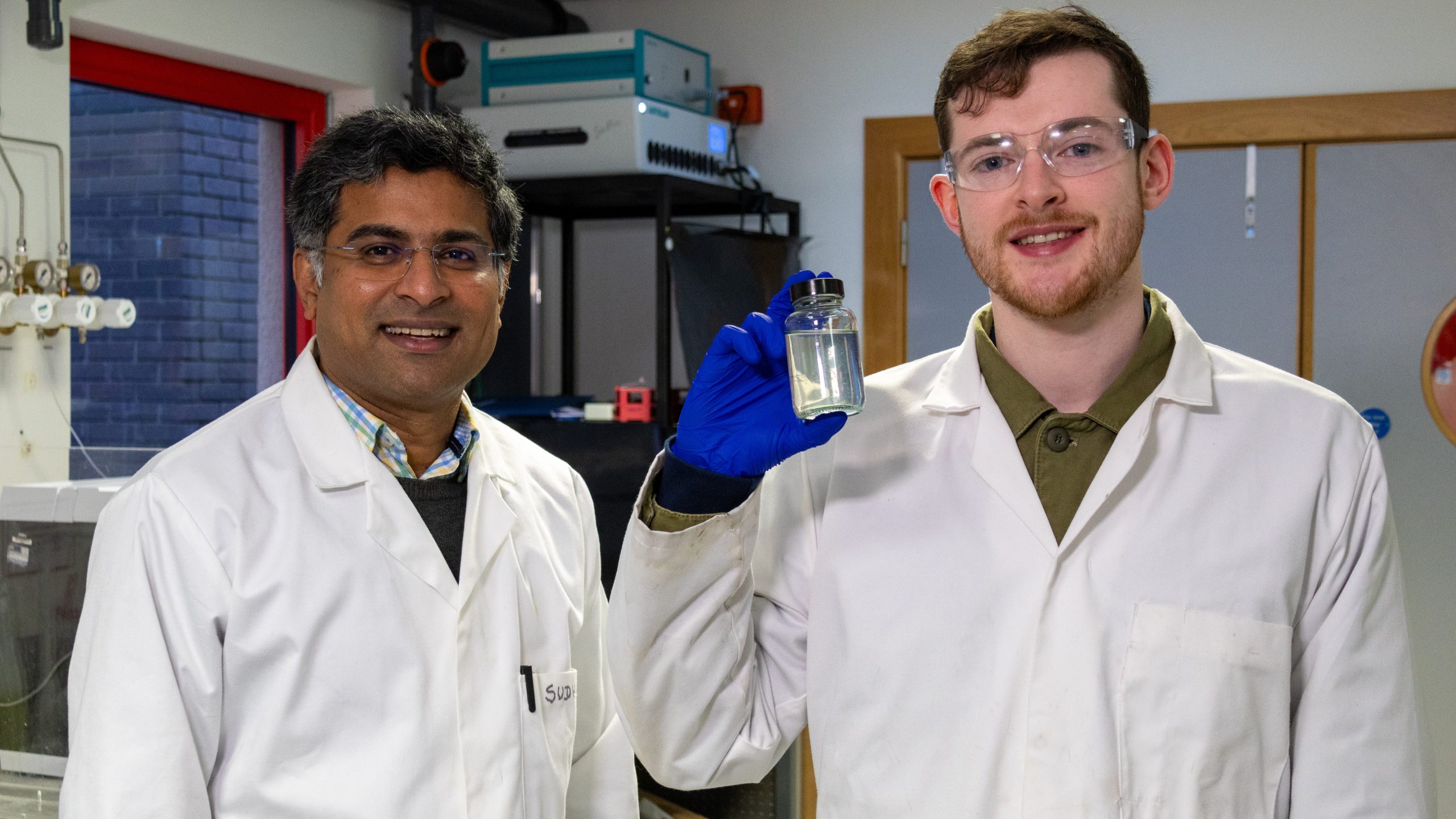 Heriot-Watt materials scientist Dr Sudhagar Pitchaimuthu (left) and PhD student Michael Walsh with a sample of whisky distillery wastewater. 