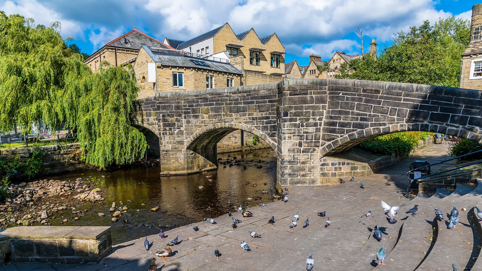 A view towards the original bridge in Hebden Bridge, Yorkshire, UK in summertime