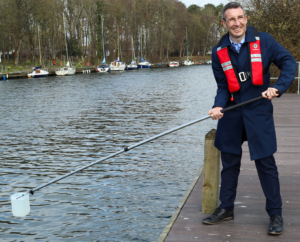 DAERA Minister Andrew Muir pictured testing out the Great UK Water Blitz kit at Antrim Lough Shore Park.