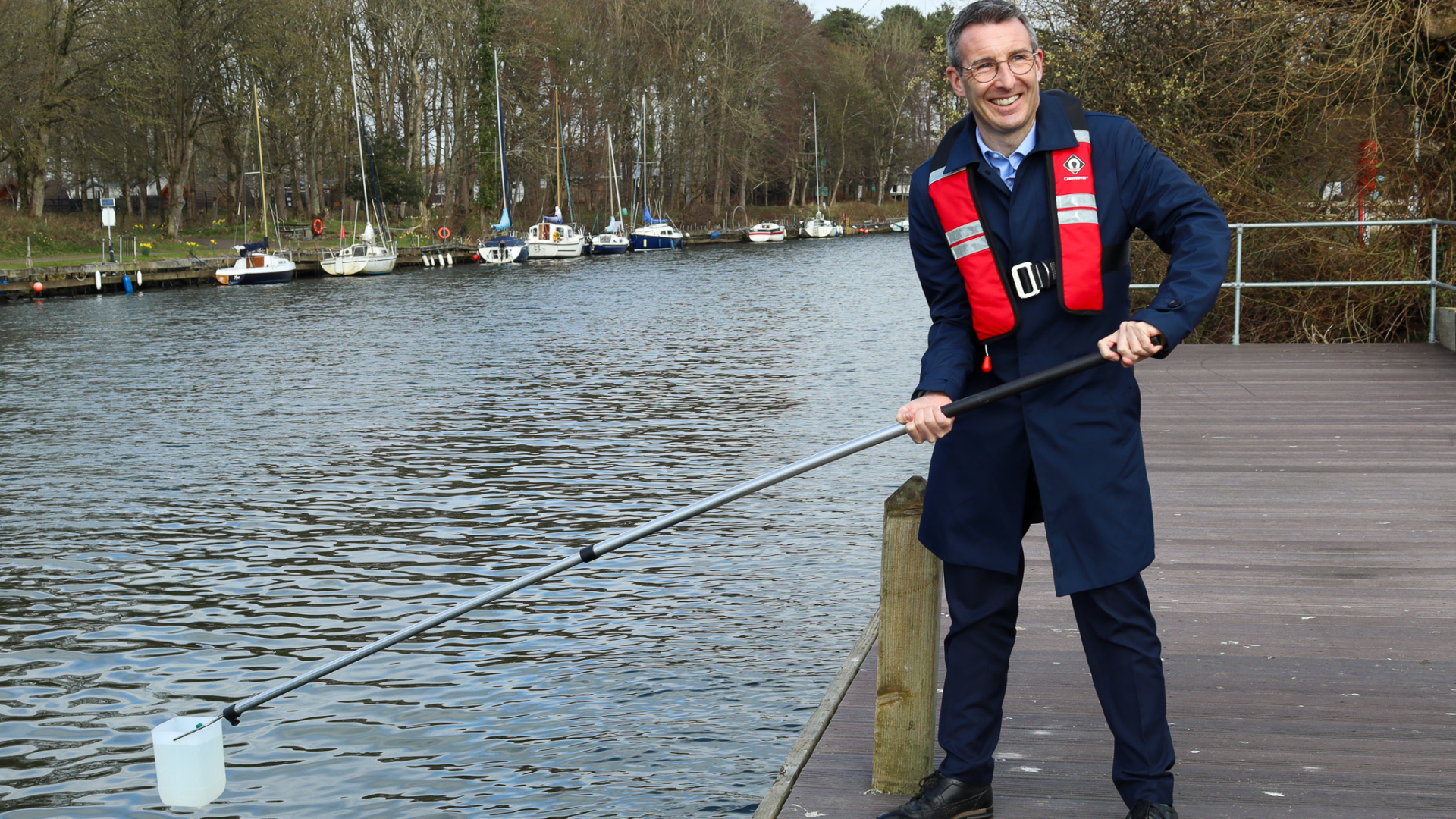 DAERA Minister Andrew Muir pictured testing out the Great UK Water Blitz kit at Antrim Lough Shore Park.